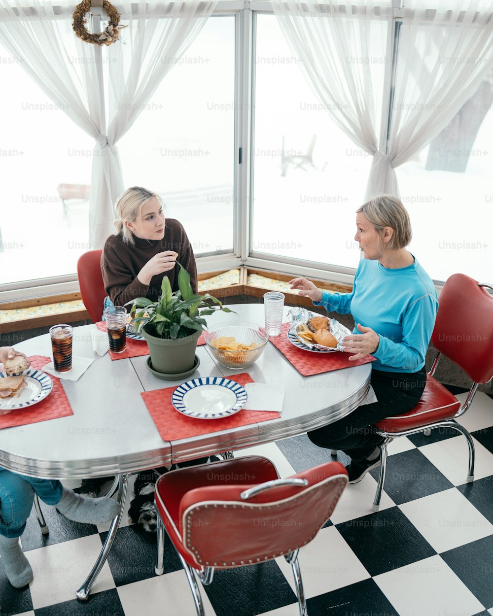 a group of people sitting around a table eating food