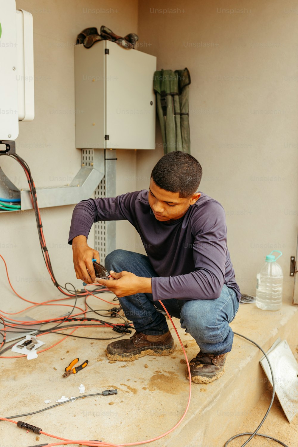 a man is working on some electrical equipment