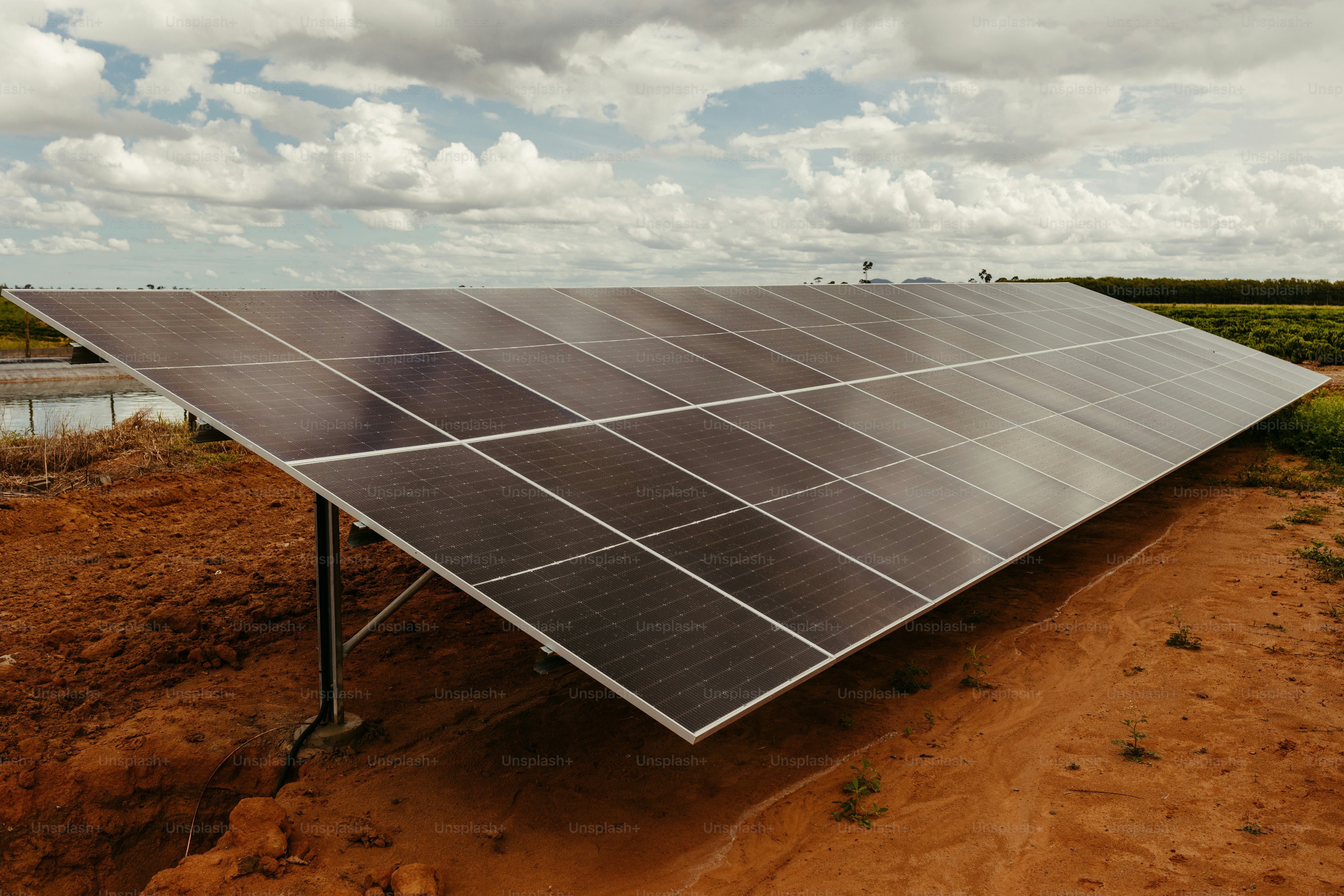 a large solar panel on a dirt field