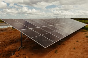 a large solar panel on a dirt field
