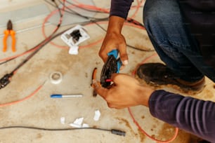 a man is working on a piece of electrical equipment