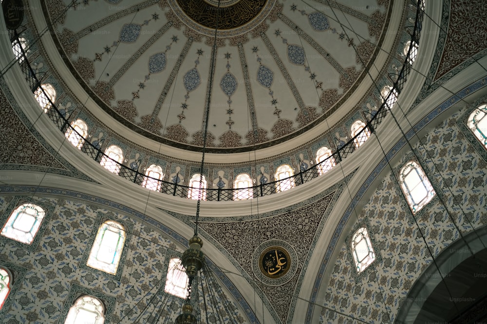 the ceiling of a large building with many windows