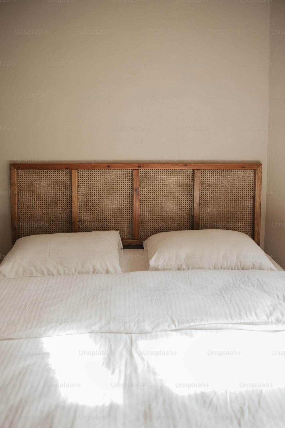 a bed with two pillows and a head board