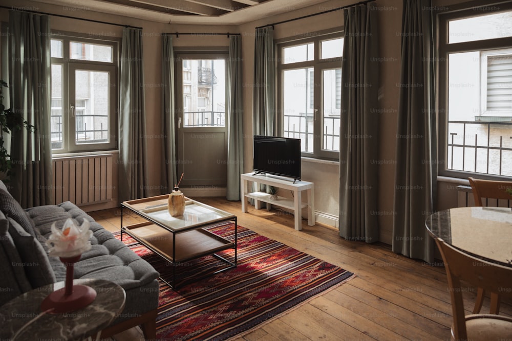 a living room filled with furniture and a flat screen tv