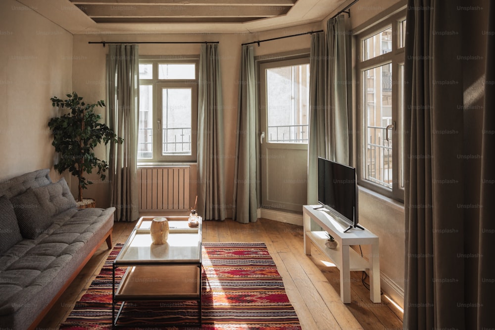 a living room filled with furniture and a flat screen tv