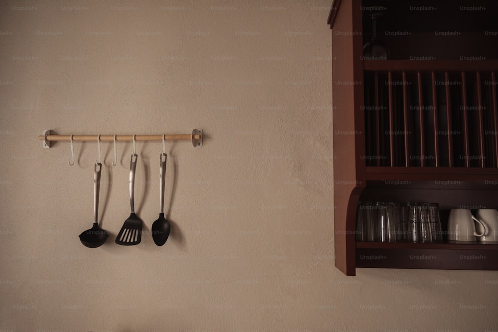 a kitchen with utensils hanging on the wall