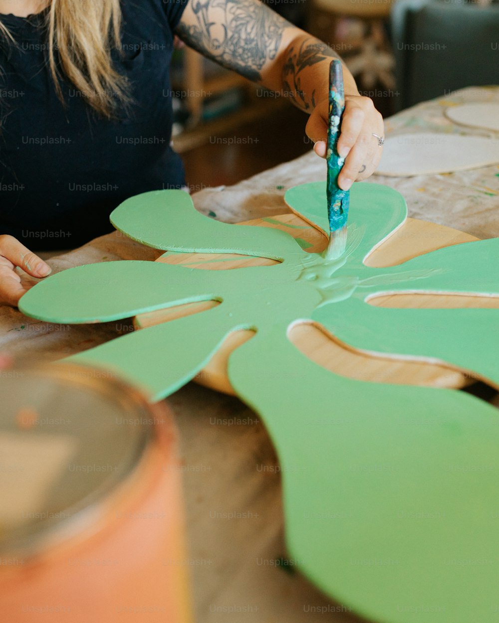 a woman is making a flower out of cardboard