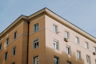 a tall building with lots of windows and a clock on the side of it