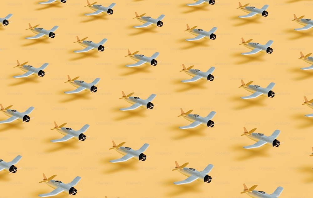 a group of small airplanes flying through a yellow sky
