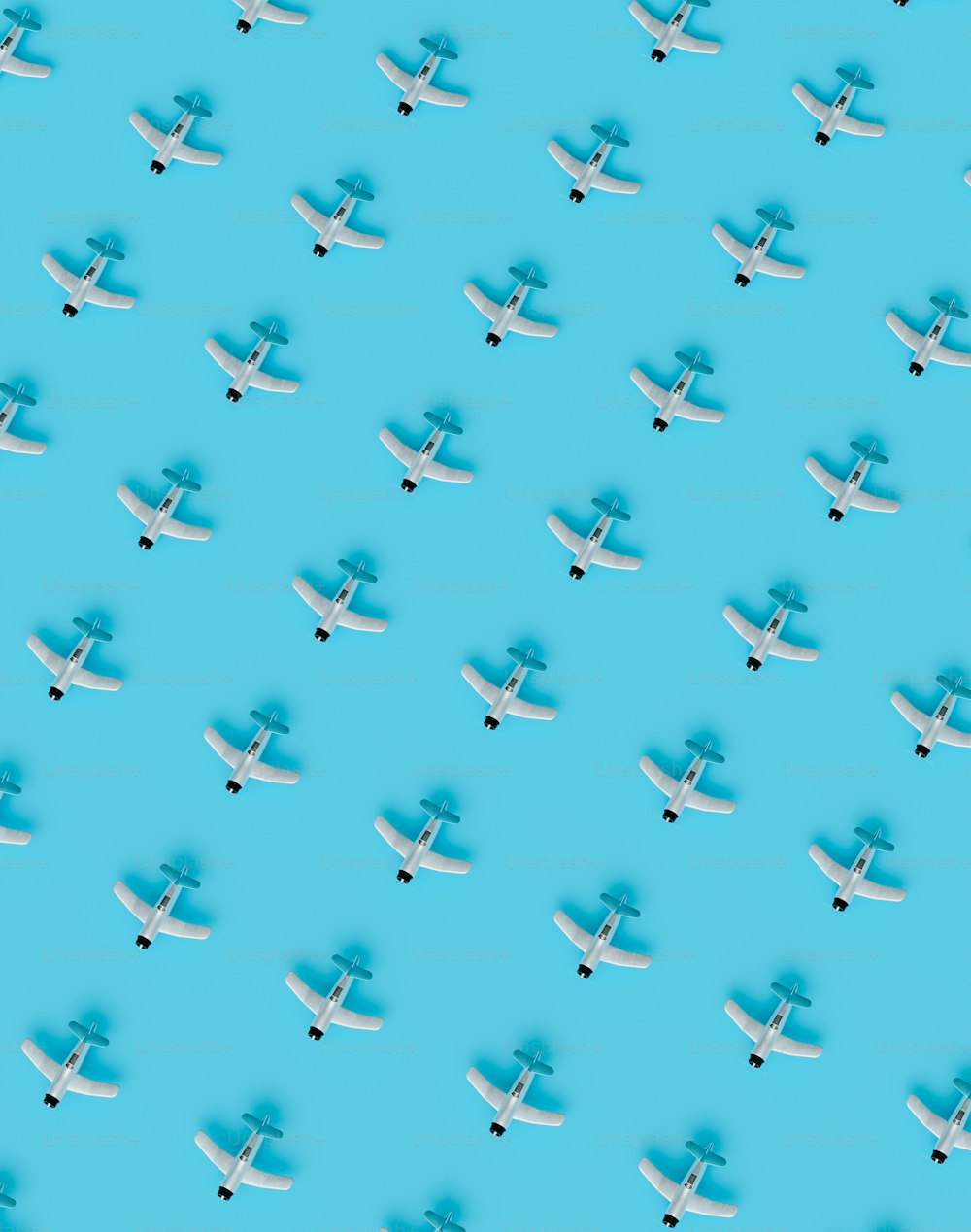 a group of airplanes flying through a blue sky