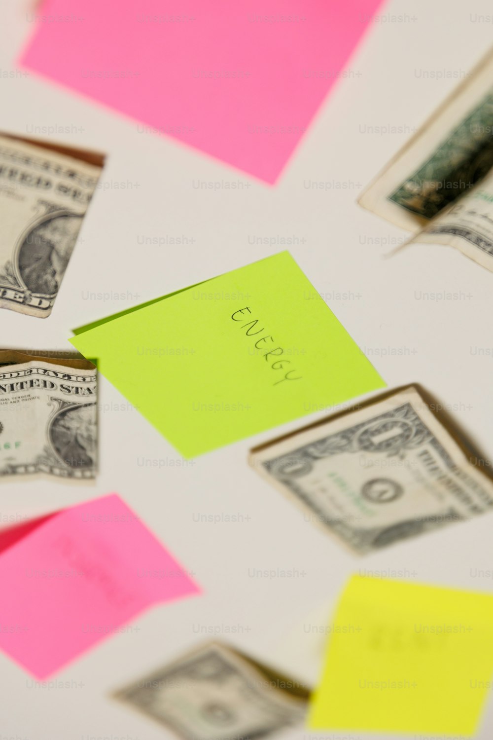 a bunch of sticky notes and money on a table