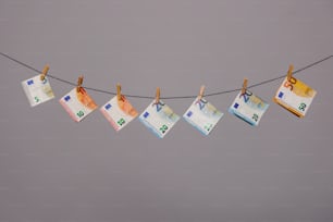 a line of money hanging from a clothes line