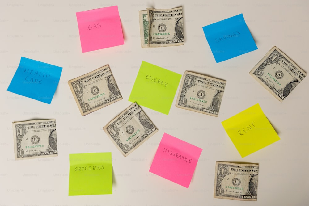 post it notes and money on a white surface