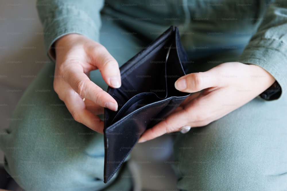 a person holding a wallet in their hands