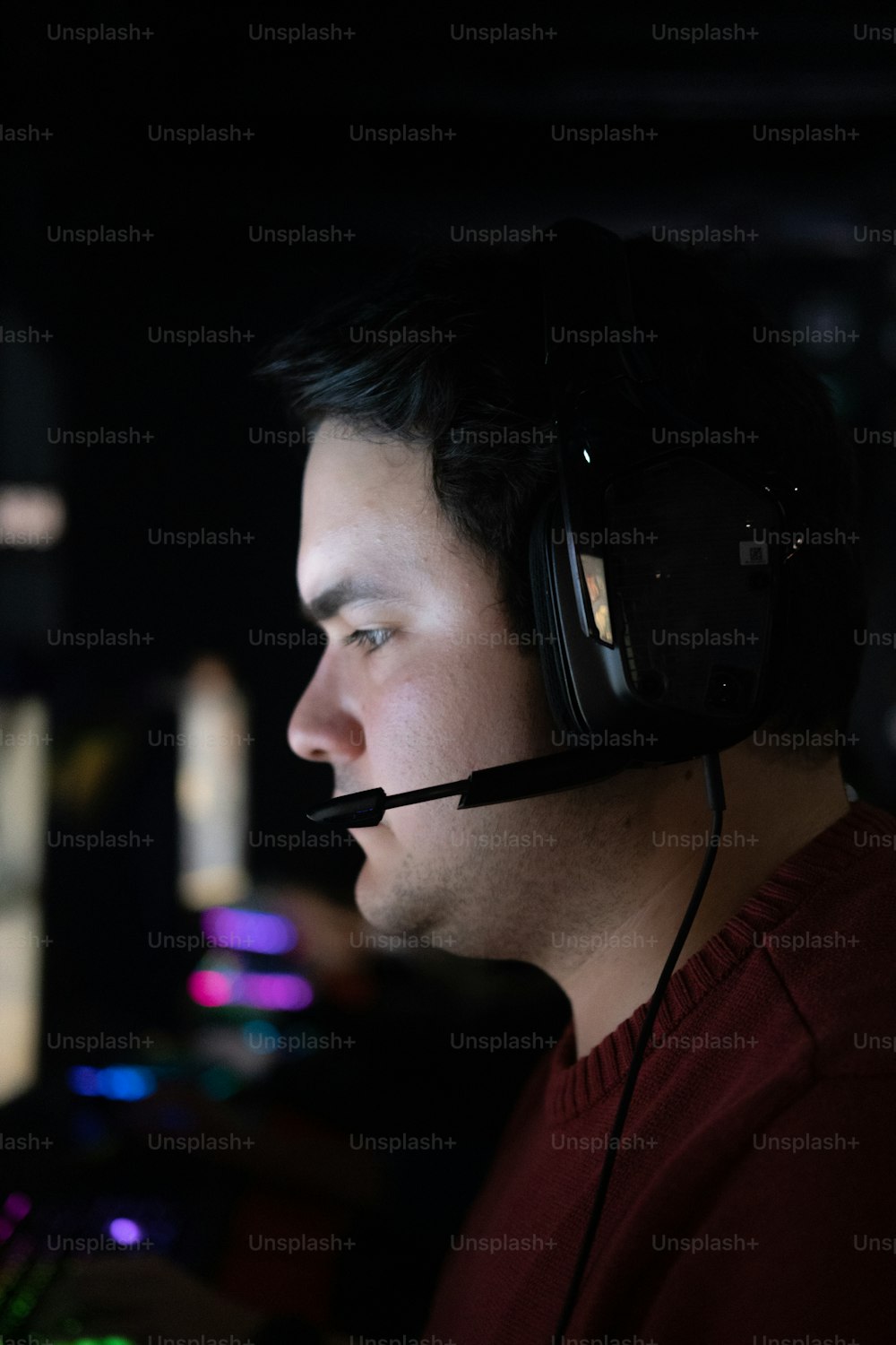 a man wearing a headset in a dark room