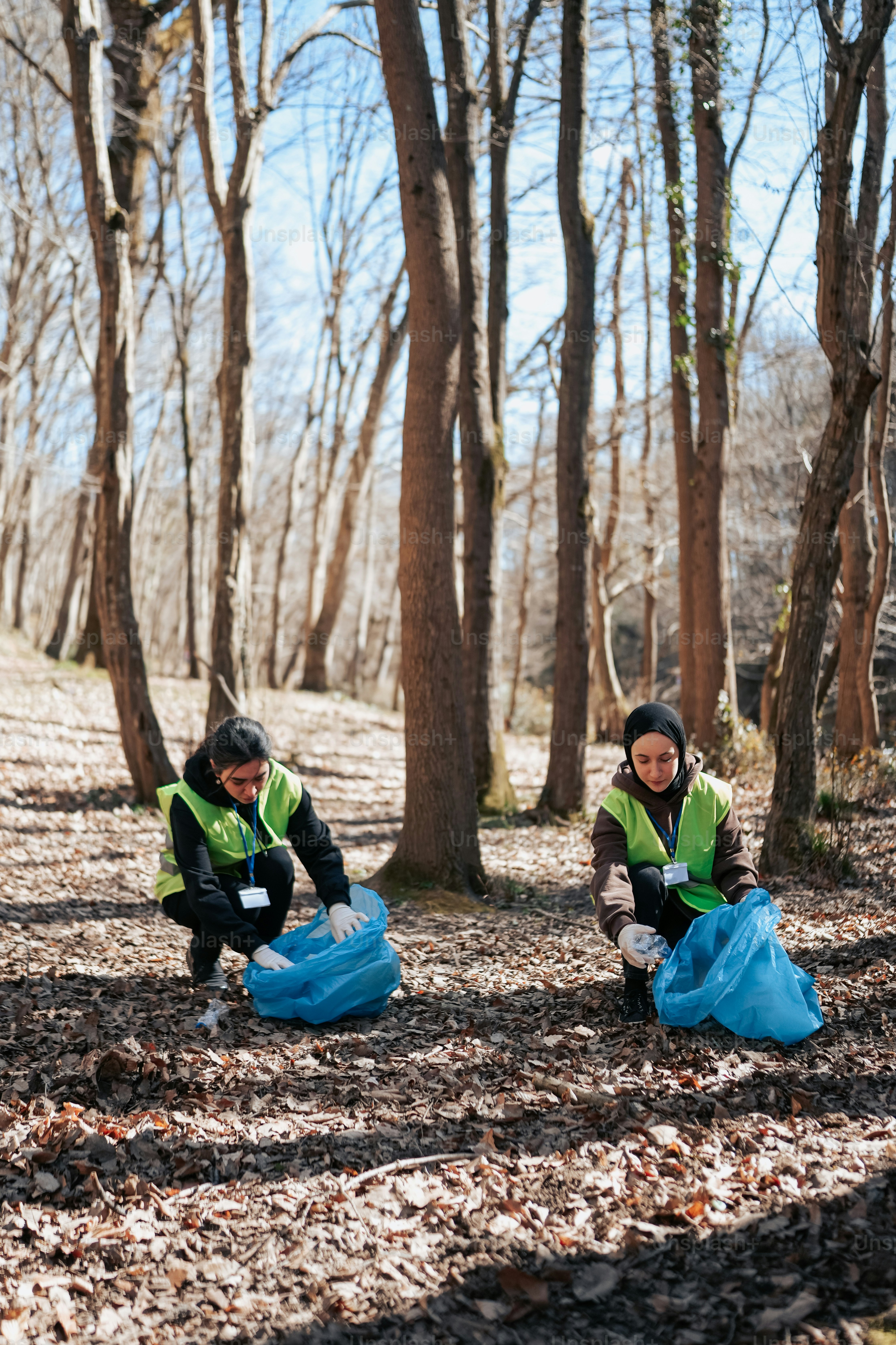 A couple of people that are kneeling down in the dirt photo – Volunteer ...