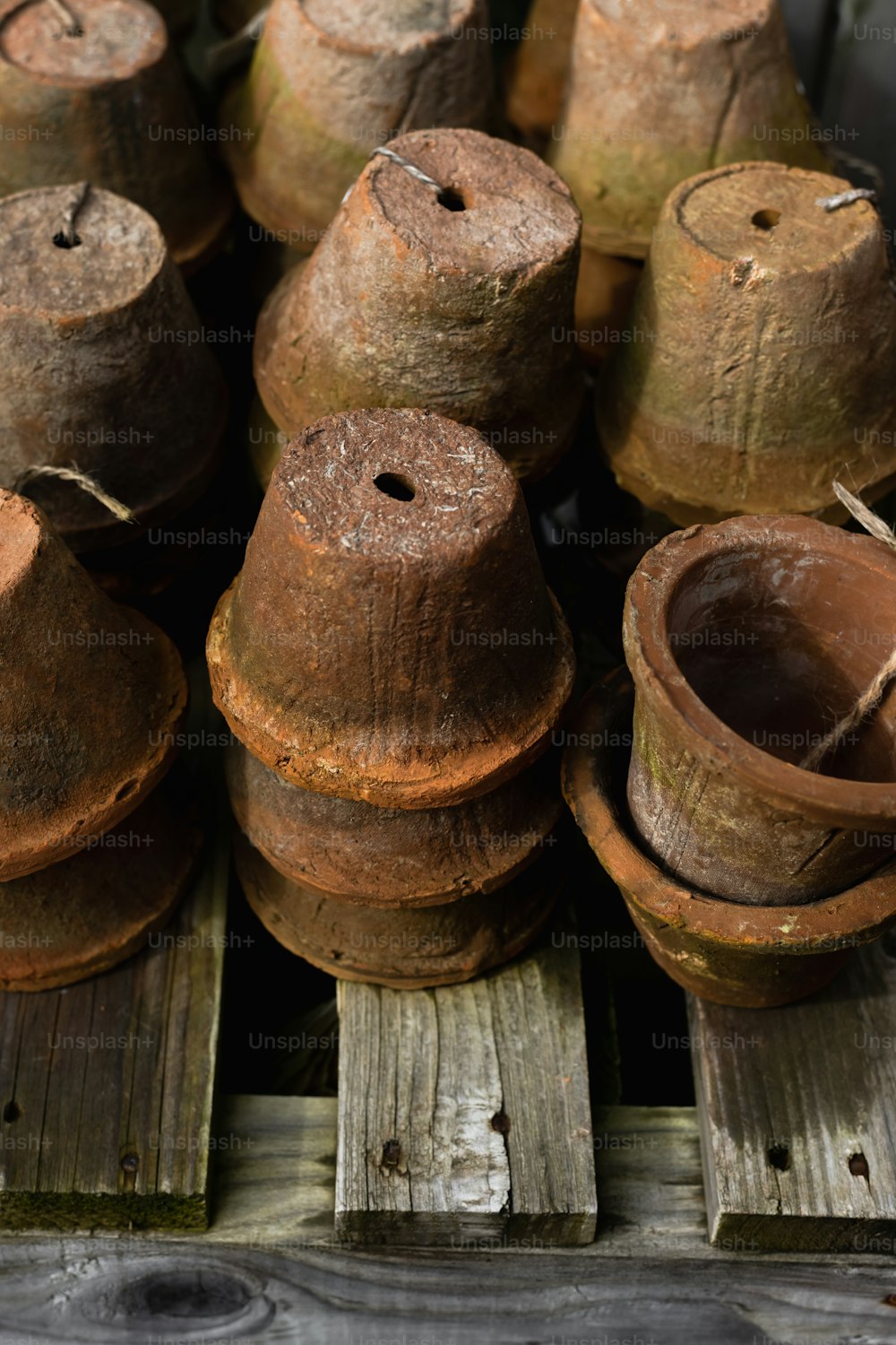 una pila di vecchi vasi di legno seduti sopra un pallet di legno