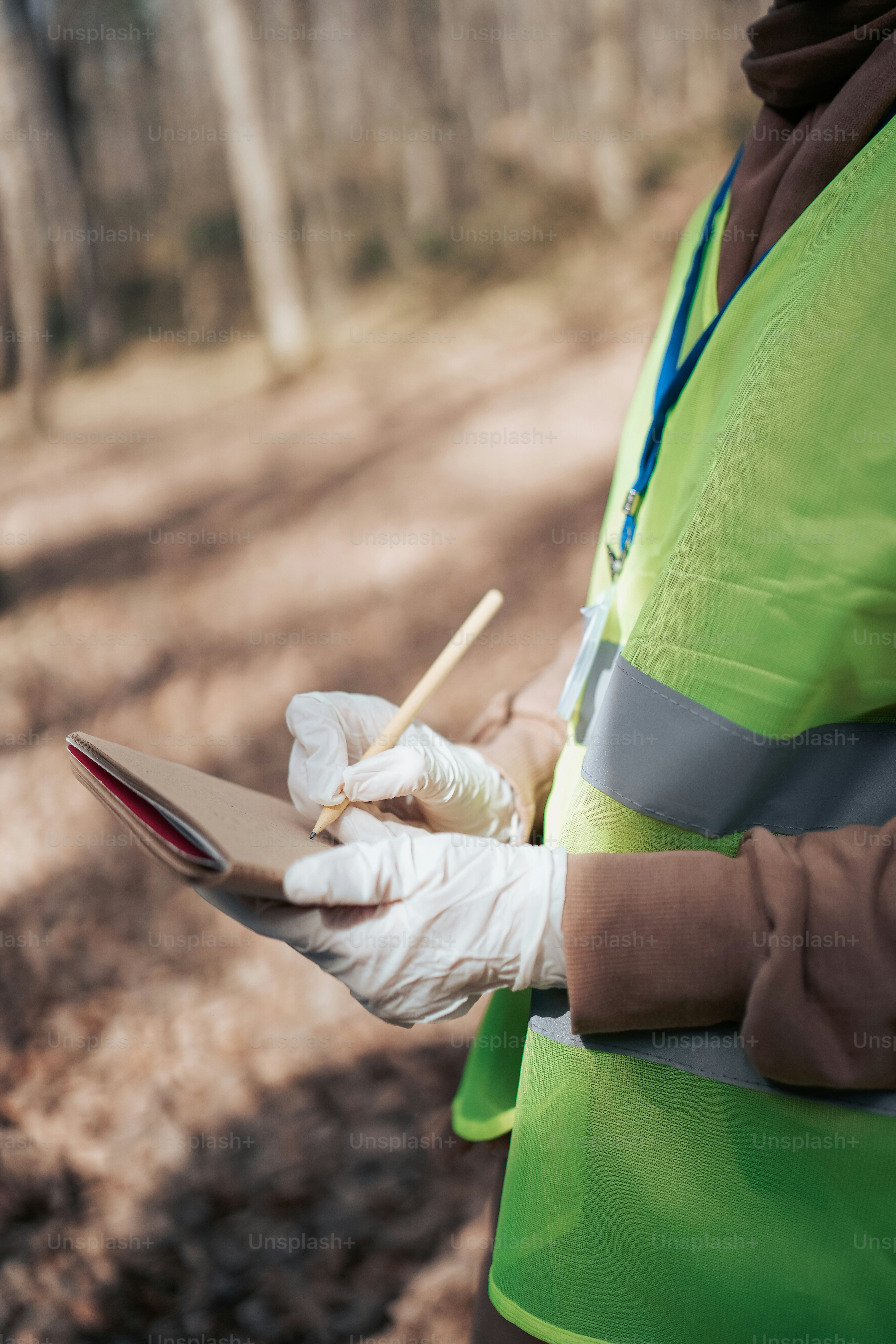 a person in a safety vest holding a piece of paper