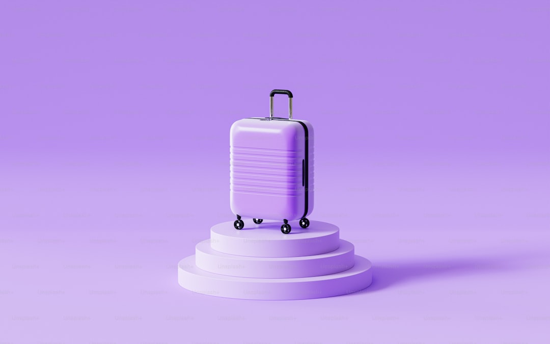 a purple suitcase on a pedestal on a purple background