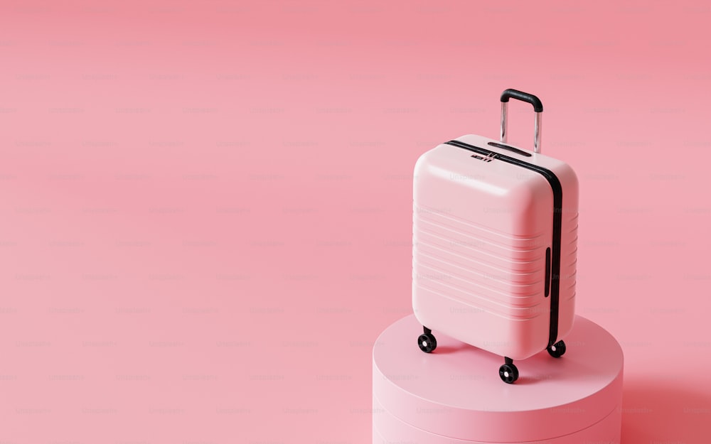 a white suitcase sitting on top of a pink pedestal