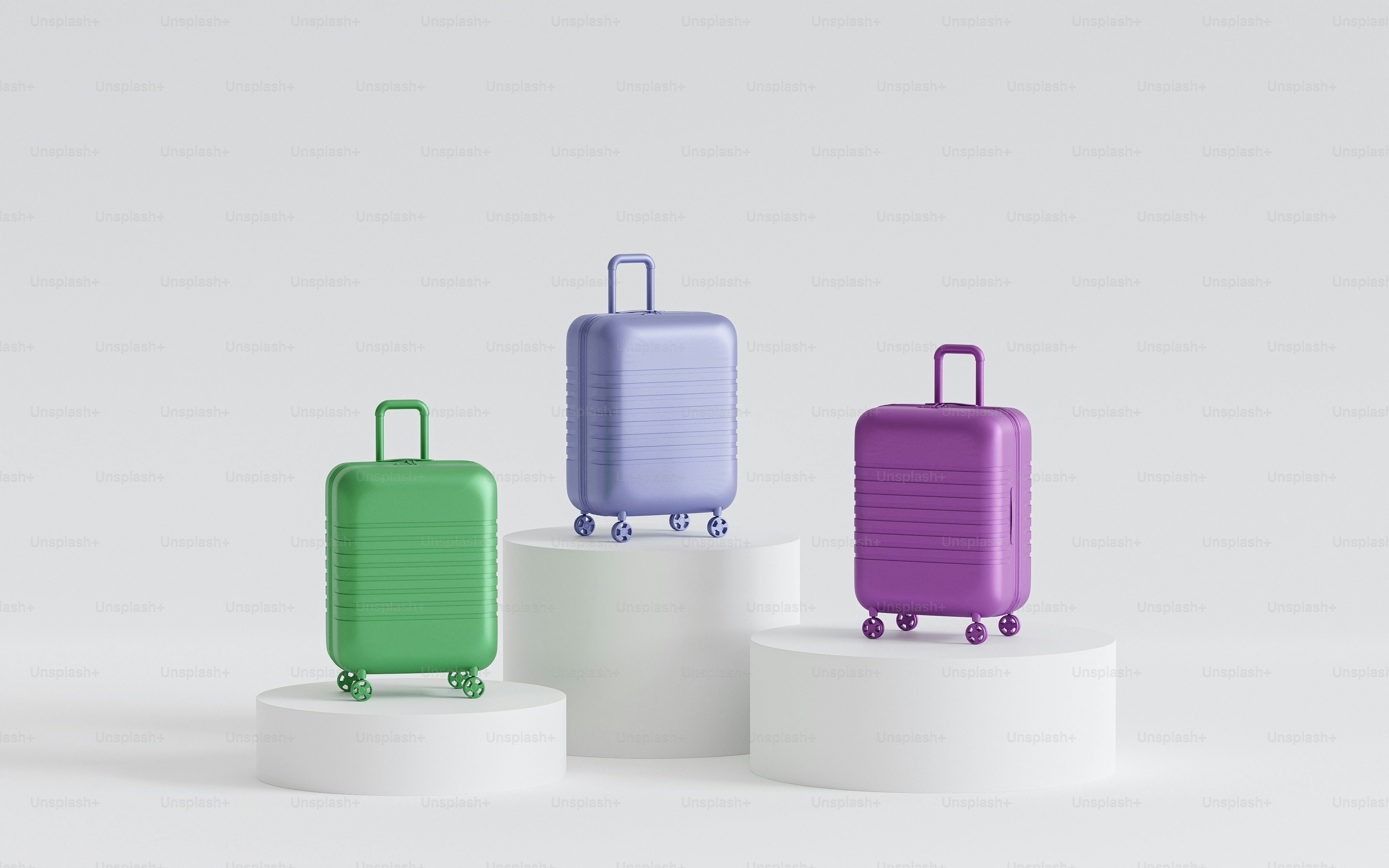 three pieces of luggage sitting on top of pedestals