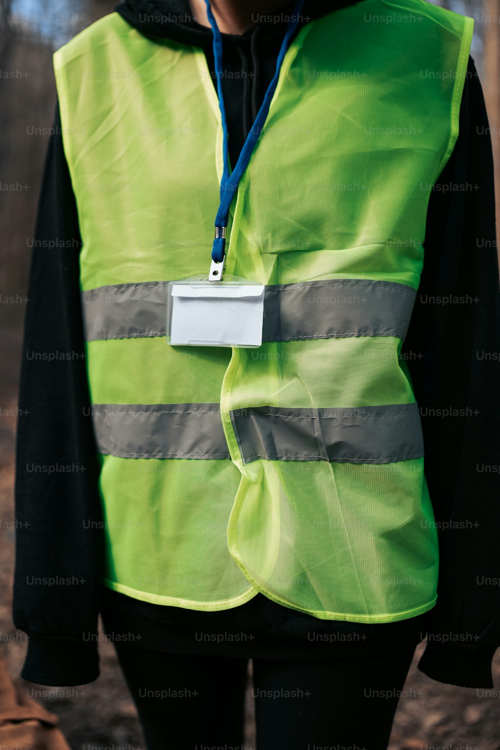 a person wearing a reflective vest with a name tag
