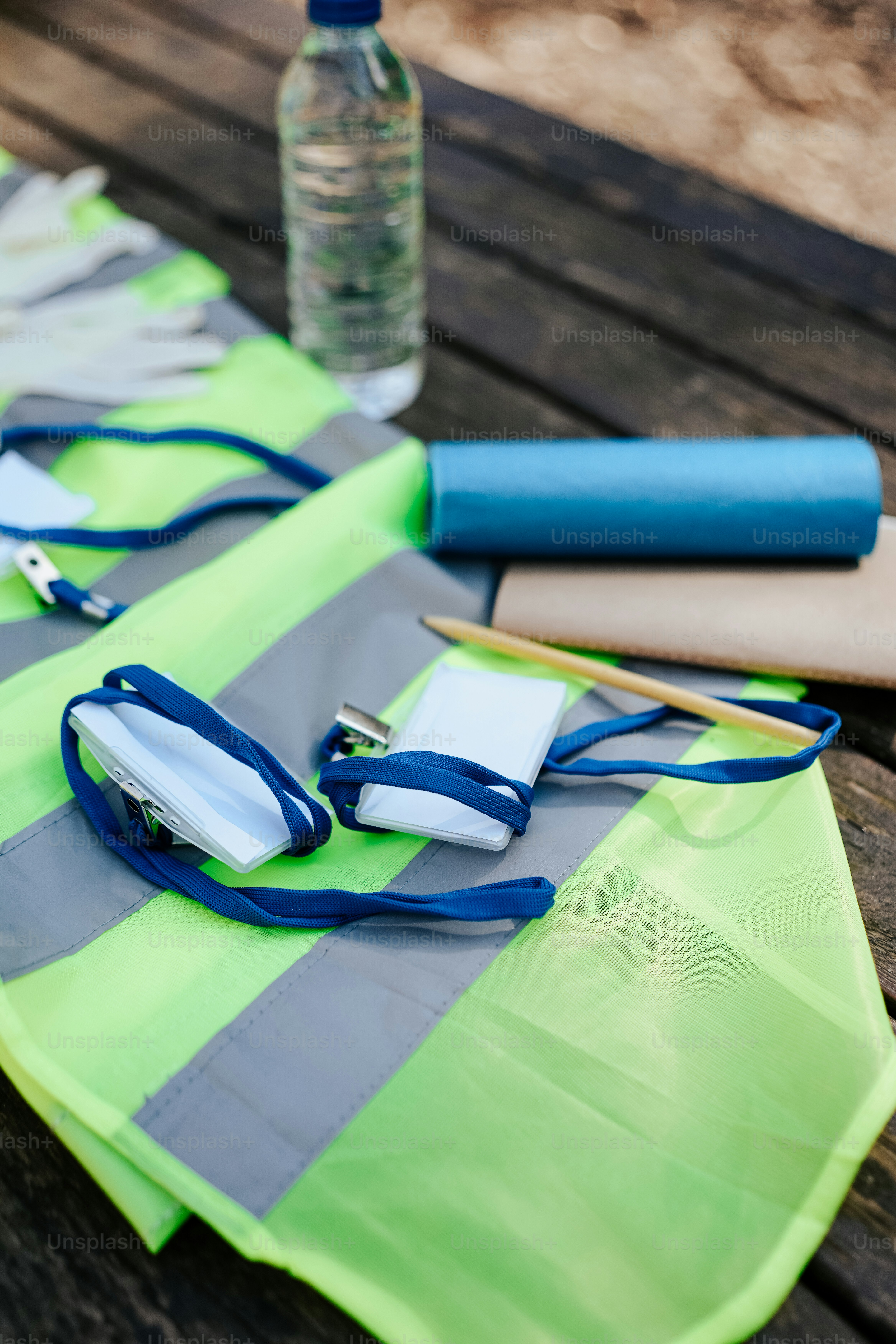 a table topped with a bottle of water and a pair of scissors