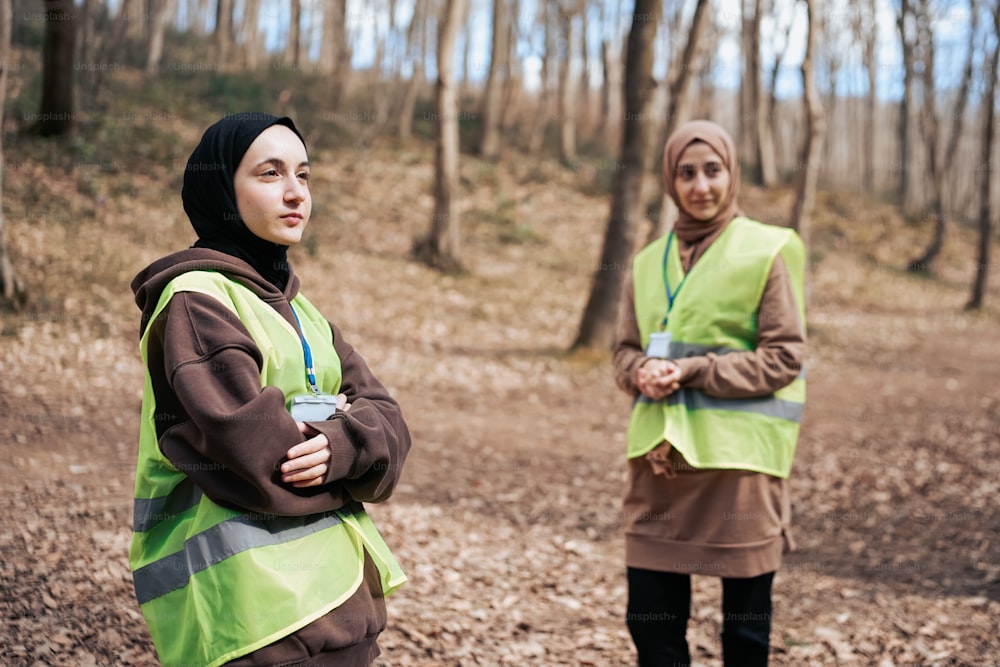 a couple of people standing in a forest