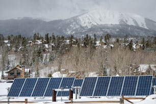a row of solar panels in the snow