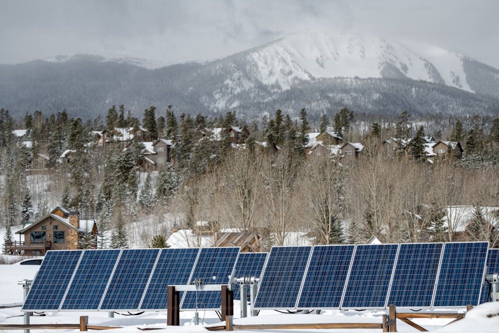 a row of solar panels in the snow