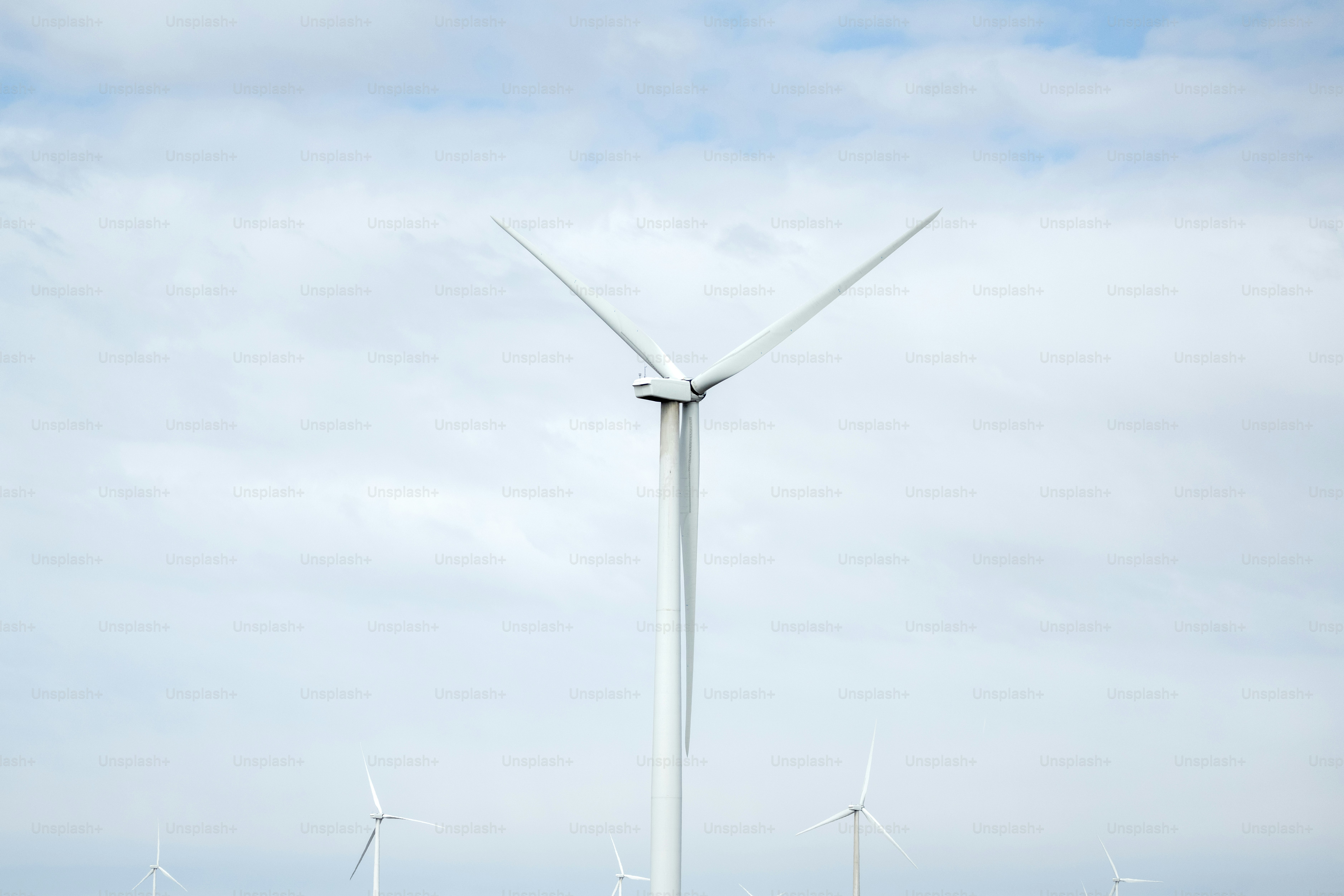 a group of wind turbines on a cloudy day