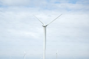 a group of wind turbines on a cloudy day