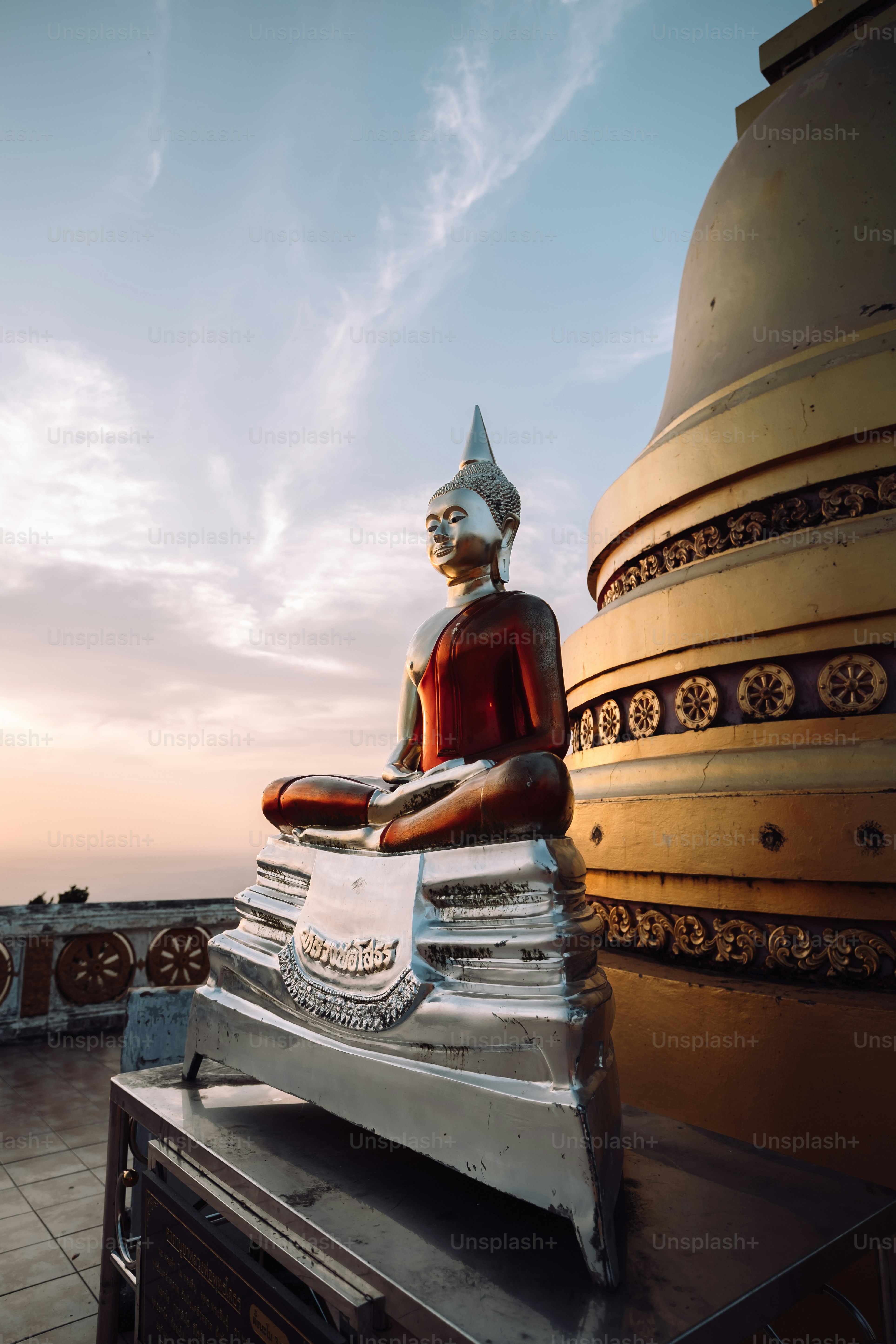 a buddha statue sitting on top of a building