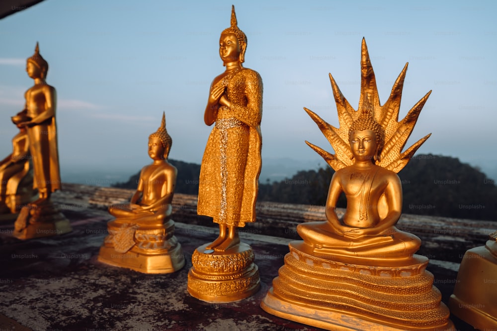 a group of golden statues sitting on top of a table