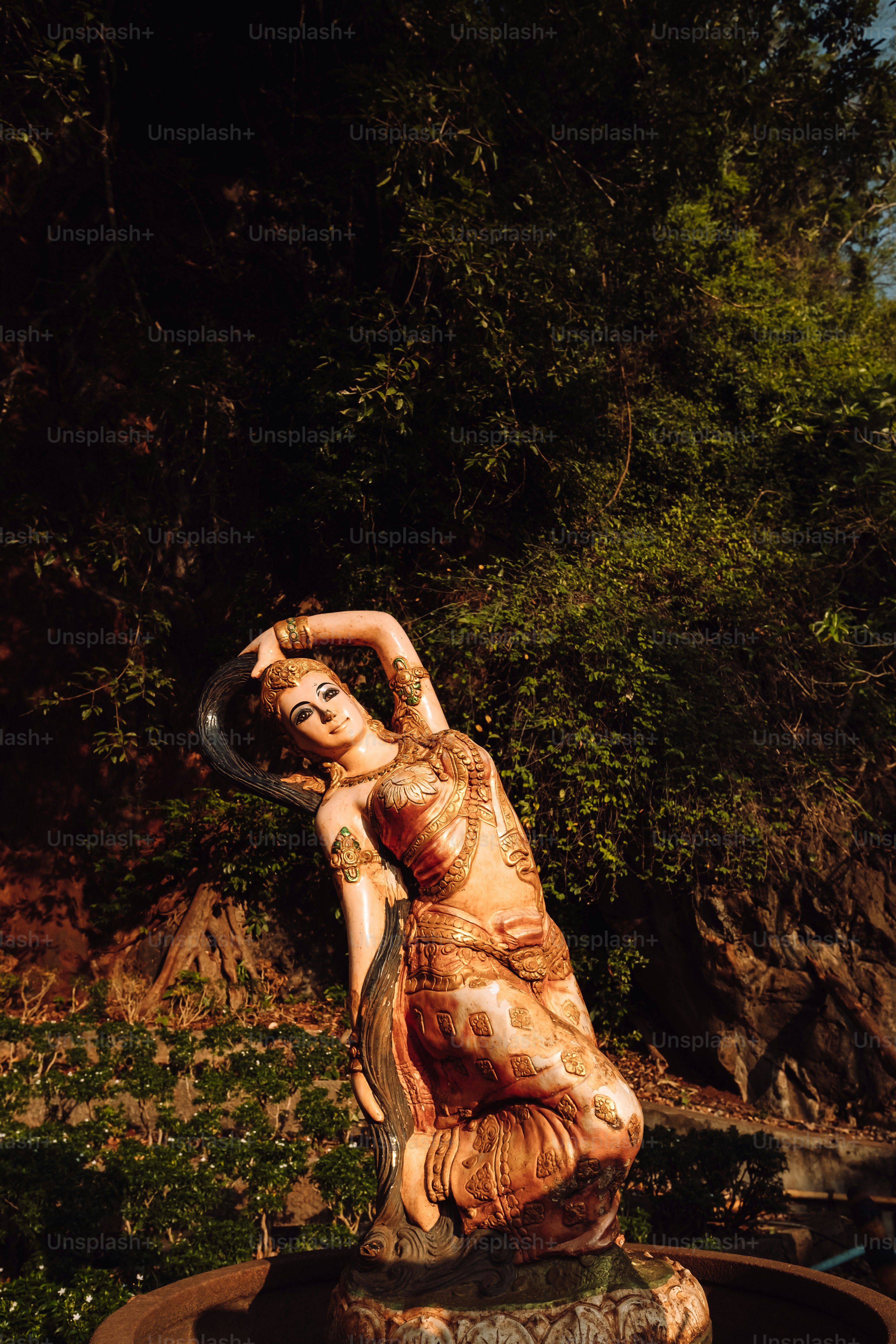 A statue of a woman sitting on top of a fountain photo – Festival Image ...