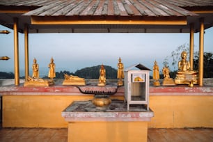 a small shrine with golden statues on top of it