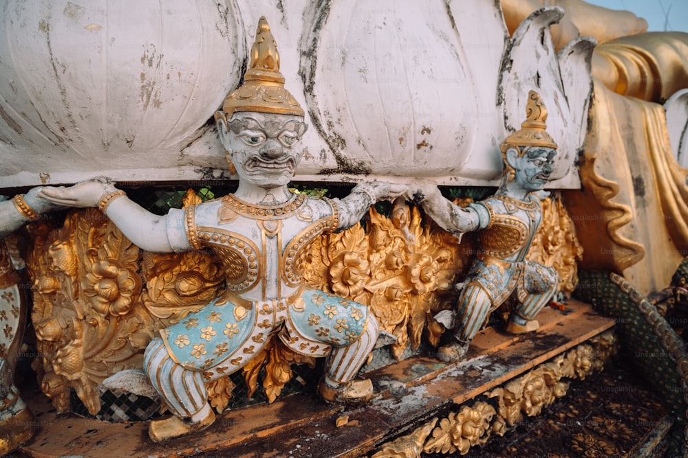 a statue of a man sitting on top of a boat