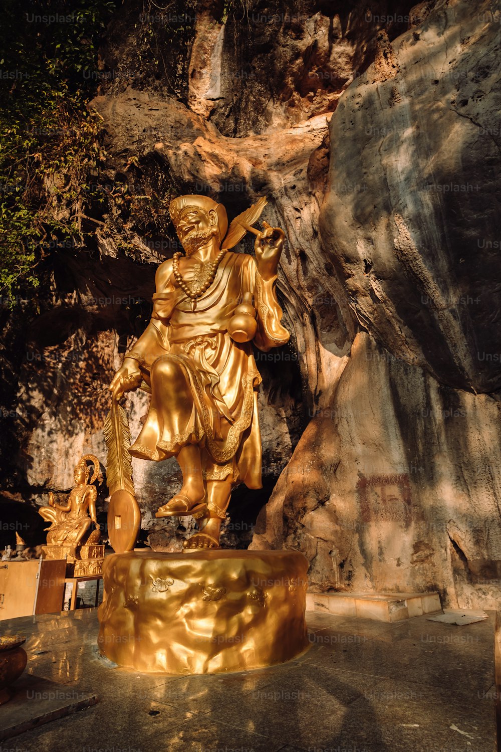 uma estátua dourada de um homem segurando uma espada
