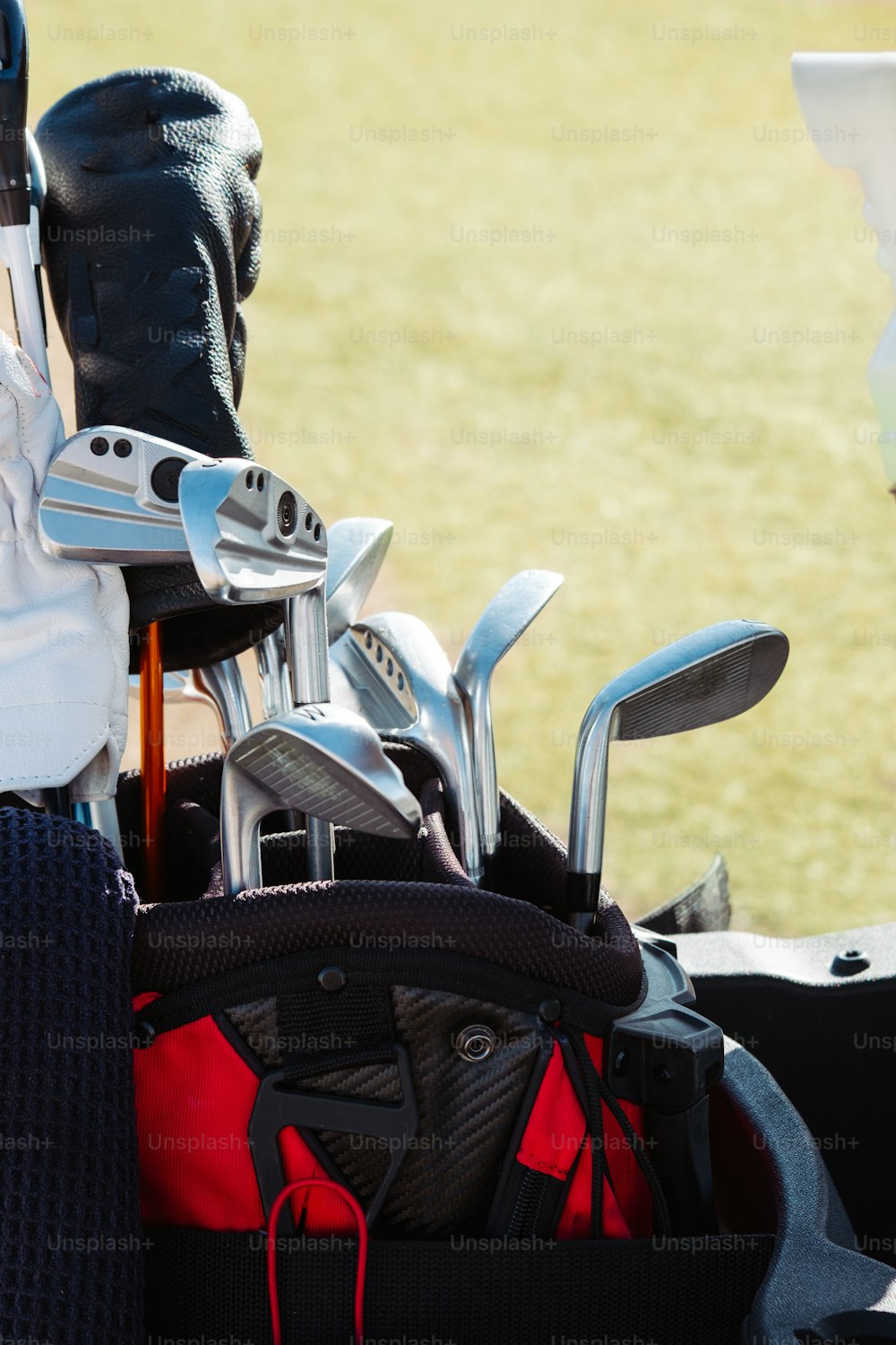 a golf bag filled with golf clubs on a field
