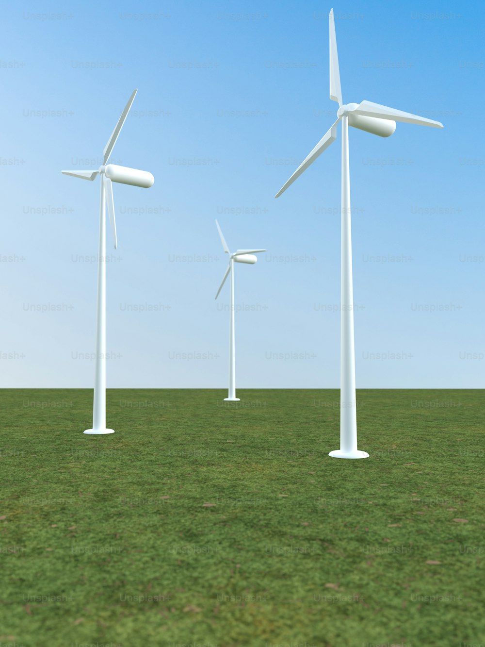 a row of wind turbines in a grassy field