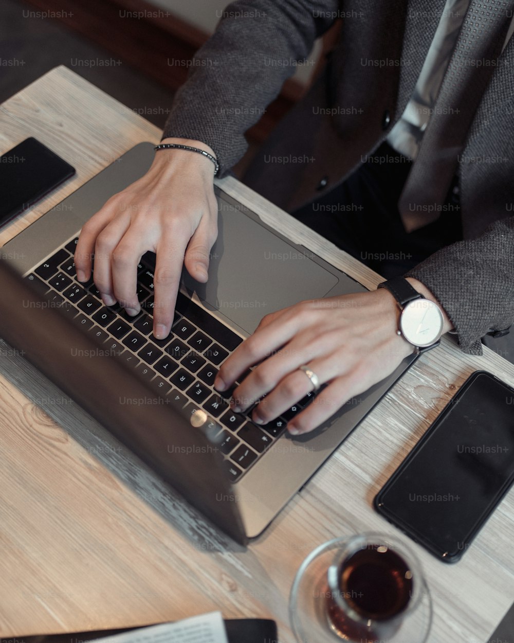 a person typing on a laptop on a table