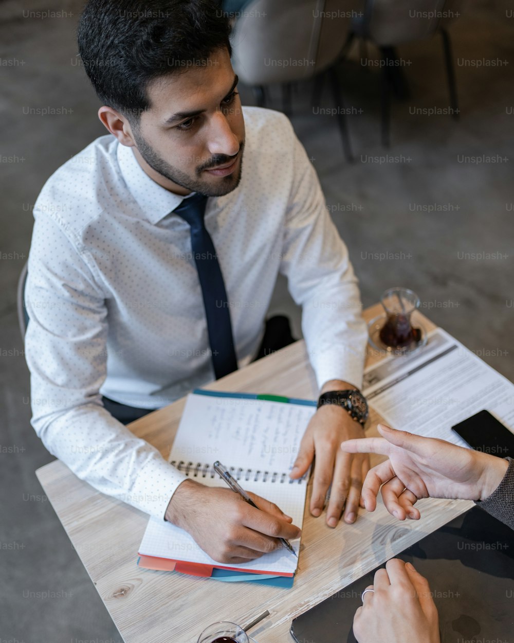 two people sitting at a table having a conversation