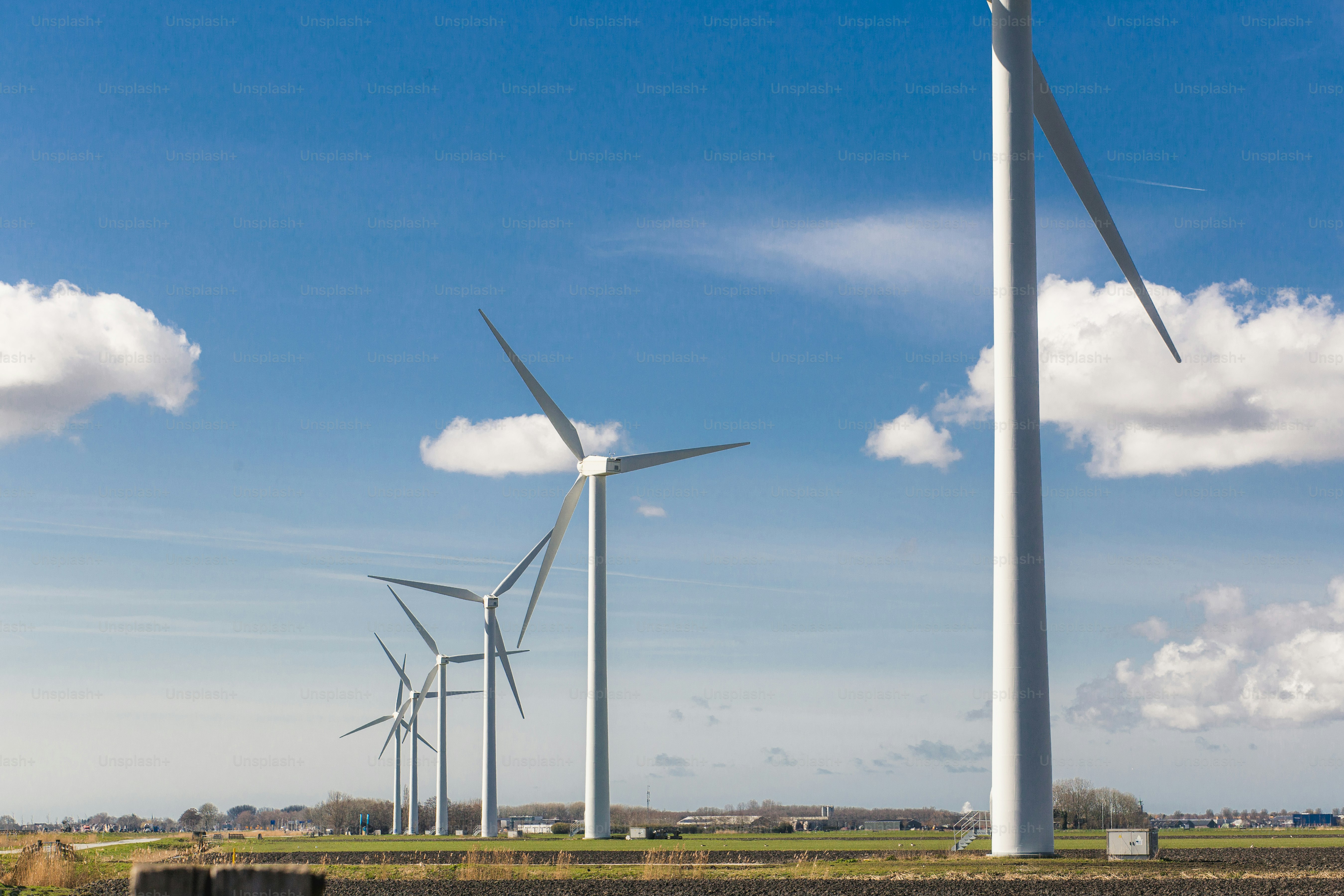 a row of wind turbines in a field