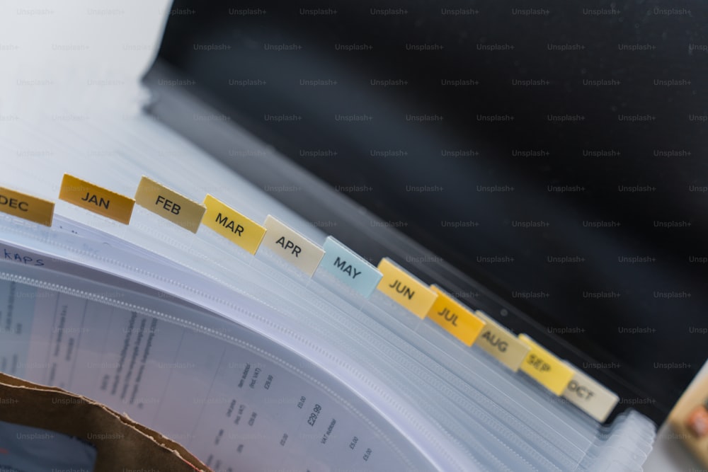 a binder with yellow and blue labels on it