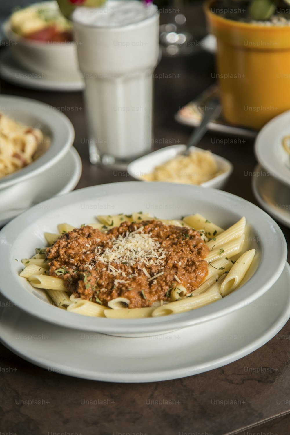 a plate of pasta with sauce and parmesan cheese