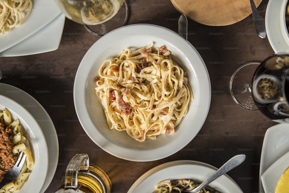 a table topped with plates of food and glasses of wine