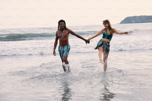 a man and a woman are walking in the water