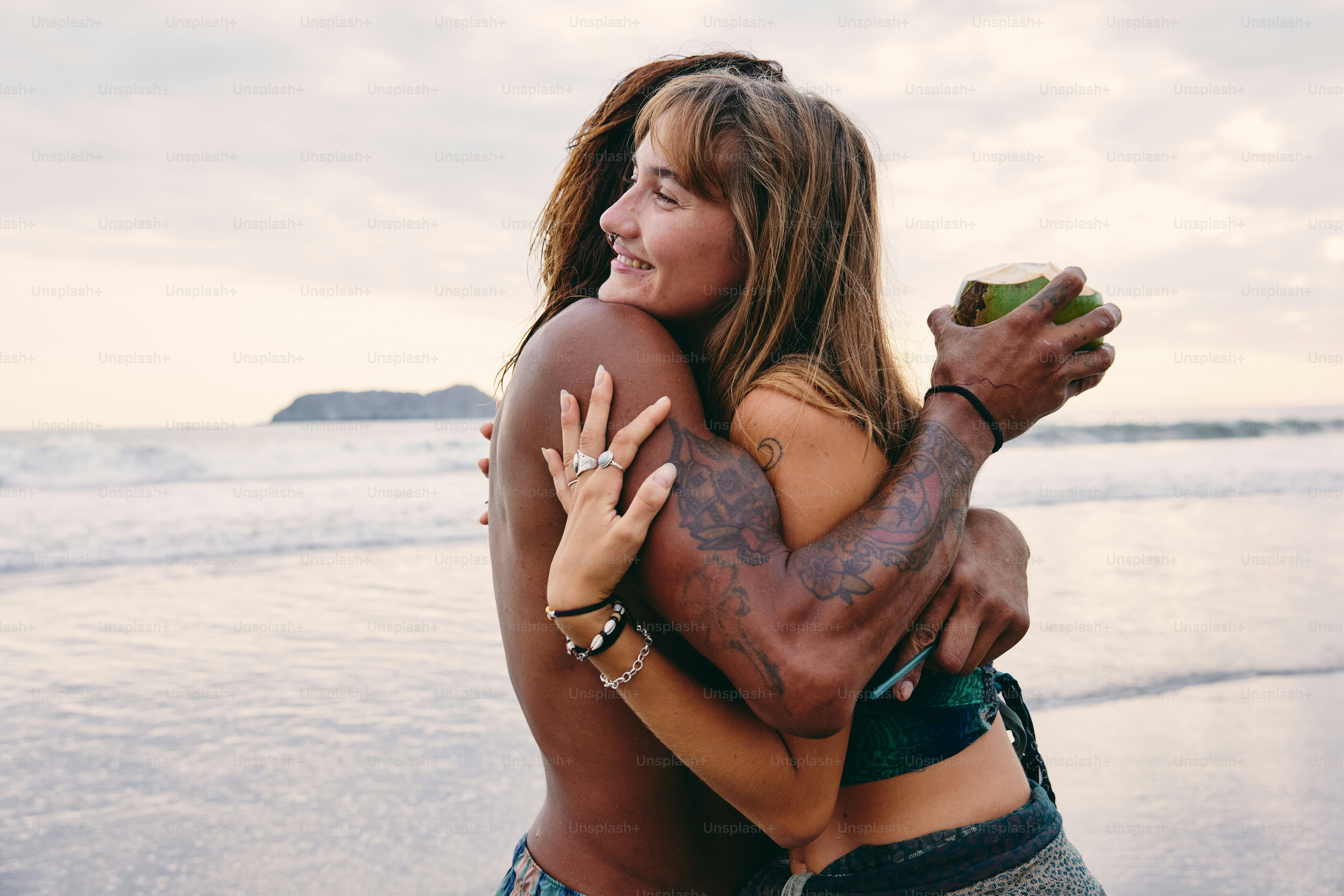 a woman hugging a man on the beach