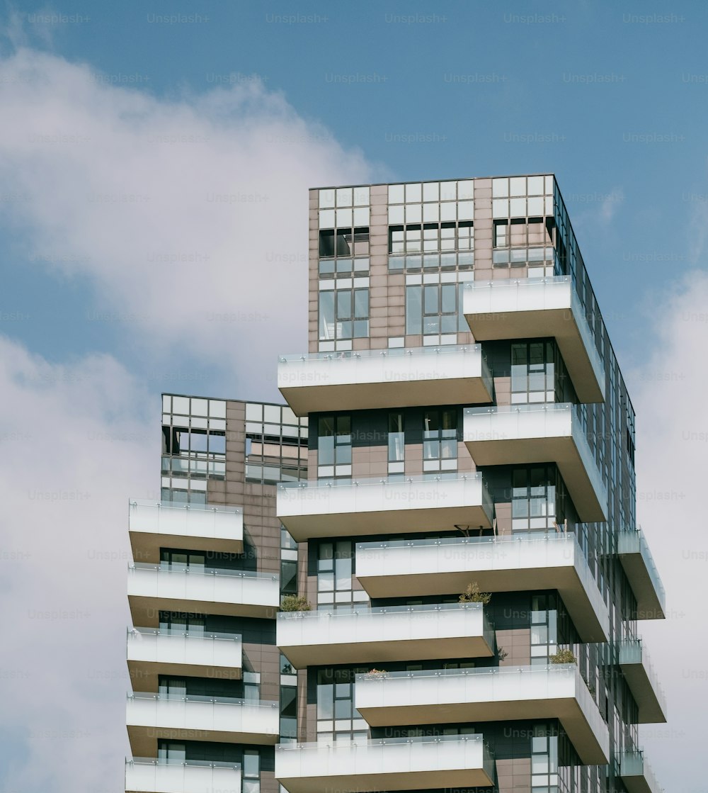 a tall building with balconies on the top of it