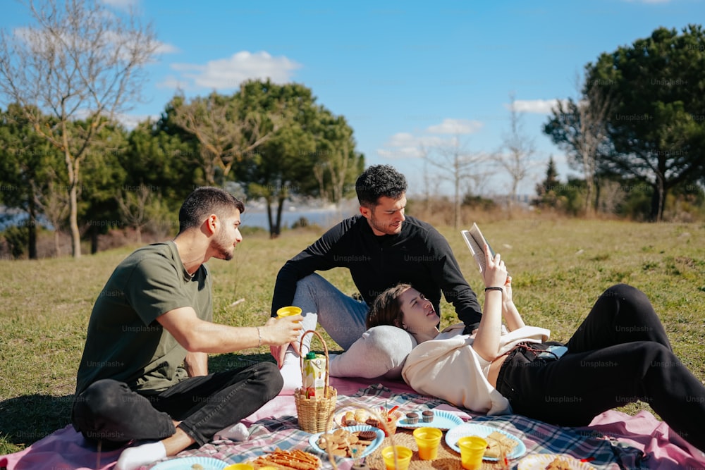 a couple of people that are laying on a blanket